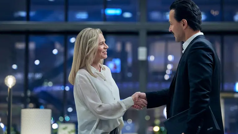 Man and woman shaking hands smiling