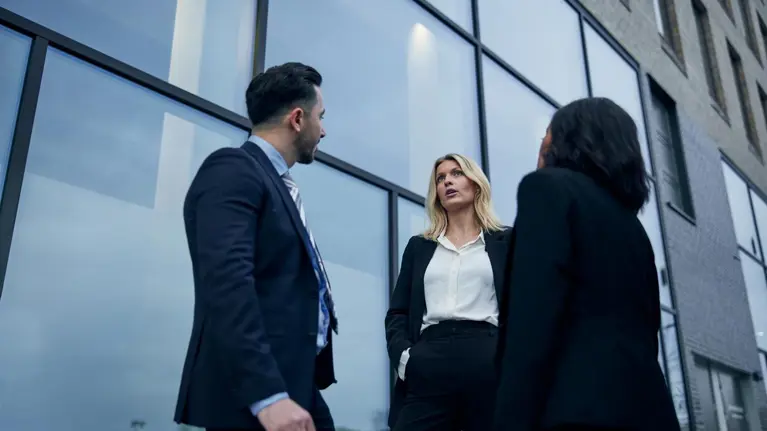 Business people talking outside office building or bank